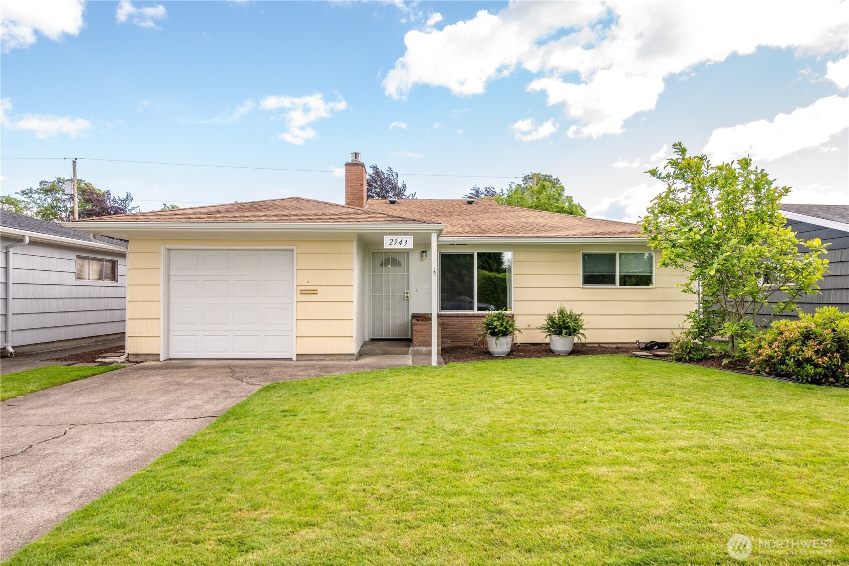 a view of a house with a yard and sitting area
