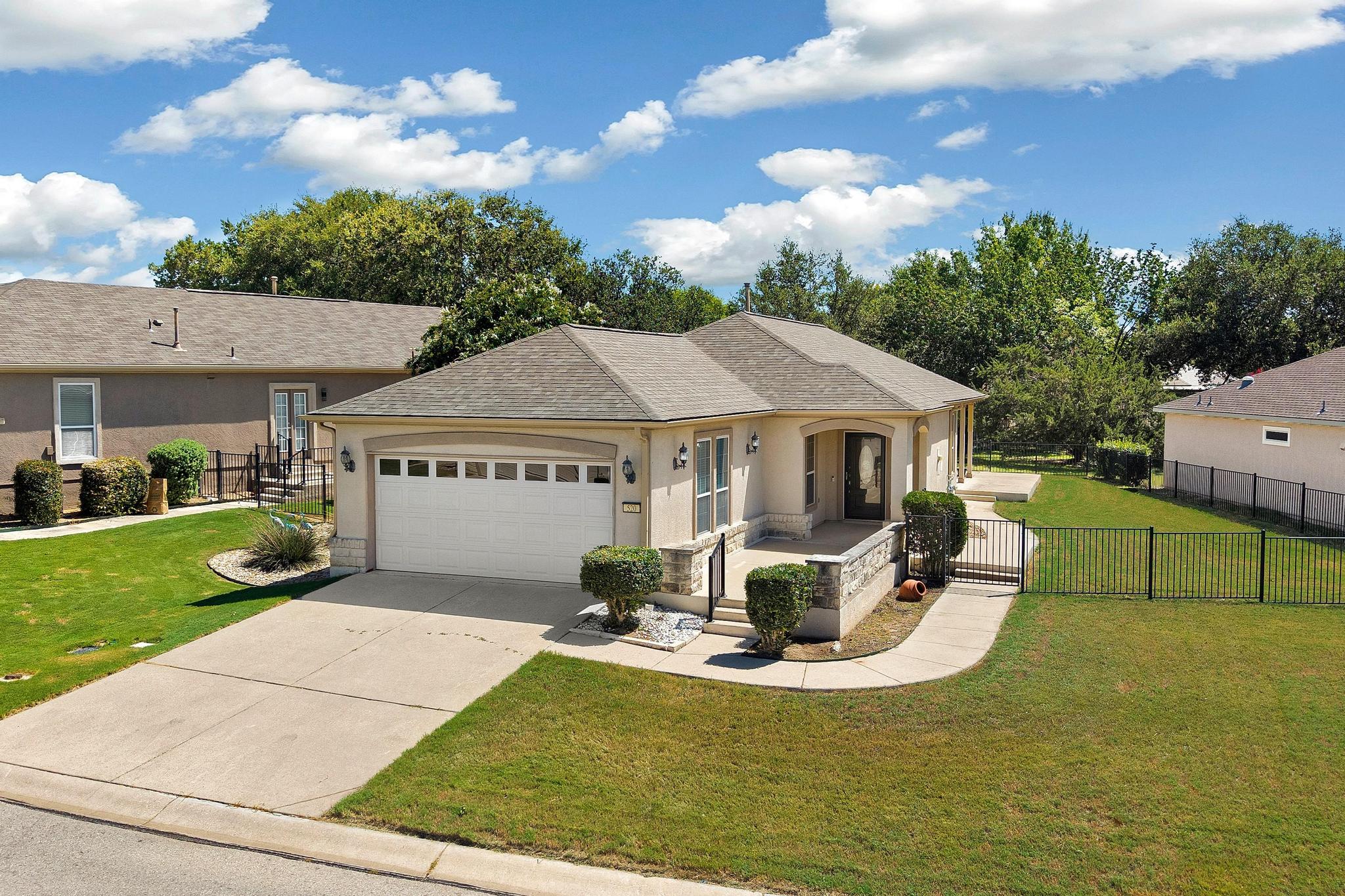 520 Mill Pond Path Georgetown, TX 78633 - Photo 4 of 38 A well-maintained single-story home with a spacious front yard and an attached garage.