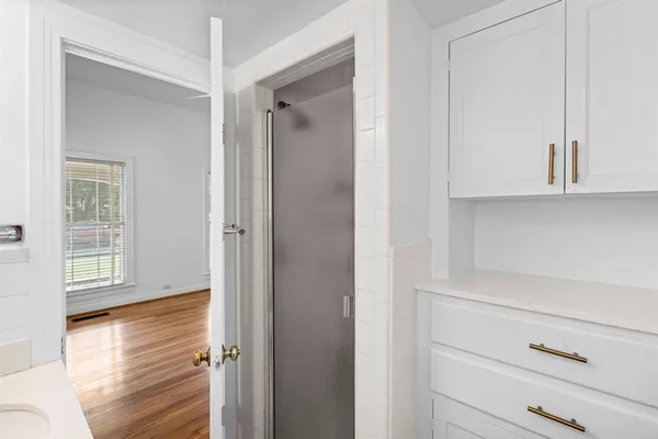 a view of an empty room with closet and a window