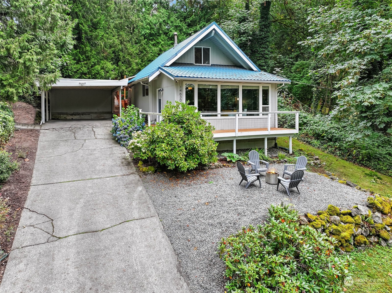a view of a house with a yard and sitting area