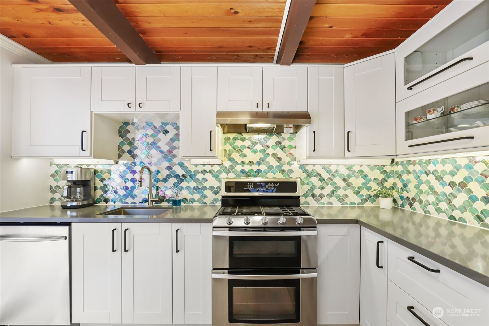 14630 200th Avenue Southeast Renton, WA 98059 - Photo 11 of 40 a kitchen with kitchen island granite countertop white cabinets and stainless steel appliances