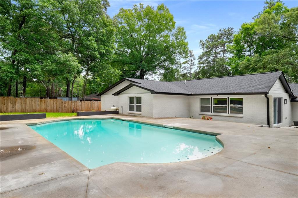 3154 North Druid Hills Road Northeast Decatur, GA 30033 - Photo 11 of 84 a view of a house with a swimming pool and sitting area
