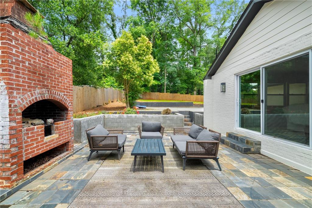 3154 North Druid Hills Road Northeast Decatur, GA 30033 - Photo 17 of 84 a backyard of a house with barbeque oven table and chairs