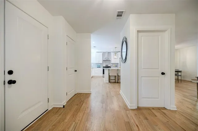 a kitchen with stainless steel appliances granite countertop a sink and dishwasher a stove top oven with wooden floor