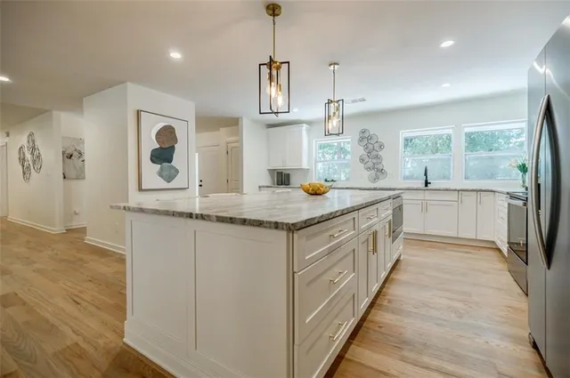 a living room with furniture and a painting on the wall