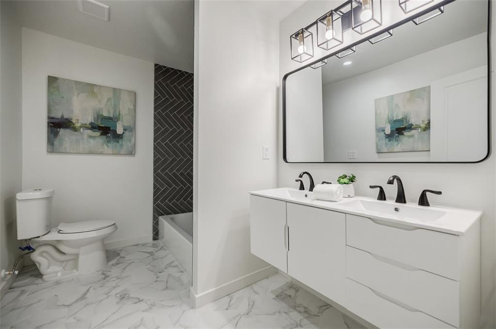 3154 North Druid Hills Road Northeast Decatur, GA 30033 - Photo 75 of 84 a bathroom with a toilet sink and mirror