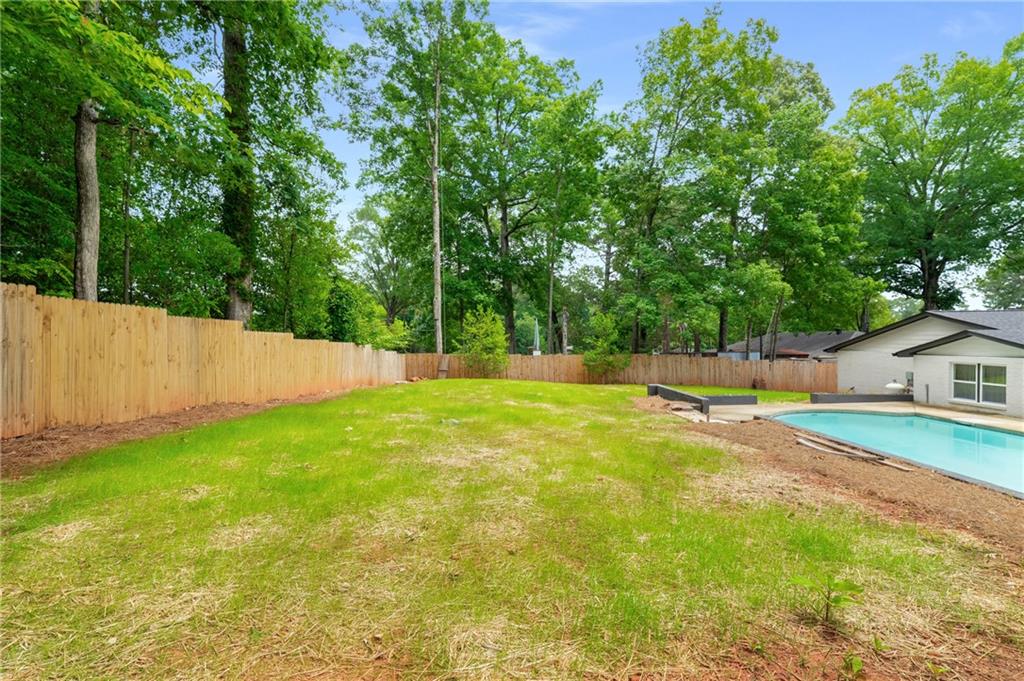3154 North Druid Hills Road Northeast Decatur, GA 30033 - Photo 9 of 84 a view of yard with swimming pool and trees in the background