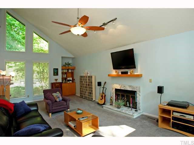 4304 Knightsbridge Way Raleigh, NC 27604 - Photo 6 of 12 a living room with furniture a fireplace and a flat screen tv