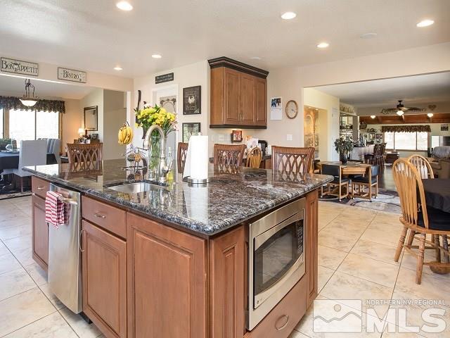 1435 Celese Lane Reno, NV 89511 - Photo 13 of 40 a kitchen with stainless steel appliances granite countertop a sink and cabinets