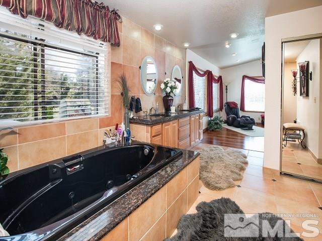 1435 Celese Lane Reno, NV 89511 - Photo 18 of 40 a kitchen with granite countertop kitchen island stainless steel appliances a sink and cabinets