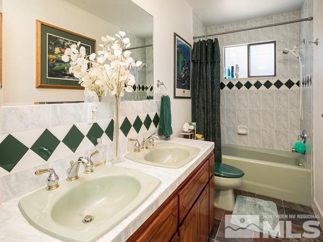 1435 Celese Lane Reno, NV 89511 - Photo 19 of 40 a bathroom with a sink a toilet and shower
