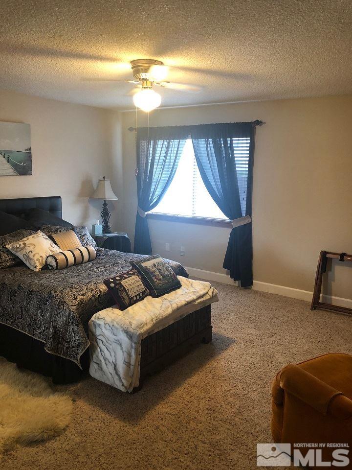 1435 Celese Lane Reno, NV 89511 - Photo 22 of 40 a bedroom with a bed and window