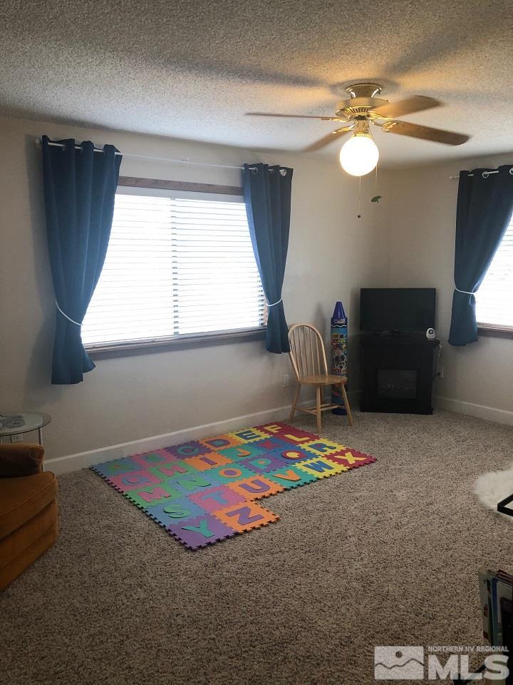 1435 Celese Lane Reno, NV 89511 - Photo 23 of 40 a bedroom with a bed and a chandelier