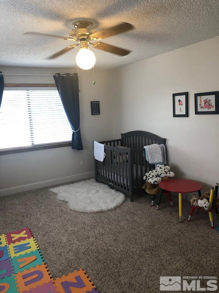 1435 Celese Lane Reno, NV 89511 - Photo 24 of 40 a bedroom with a bed and a chandelier