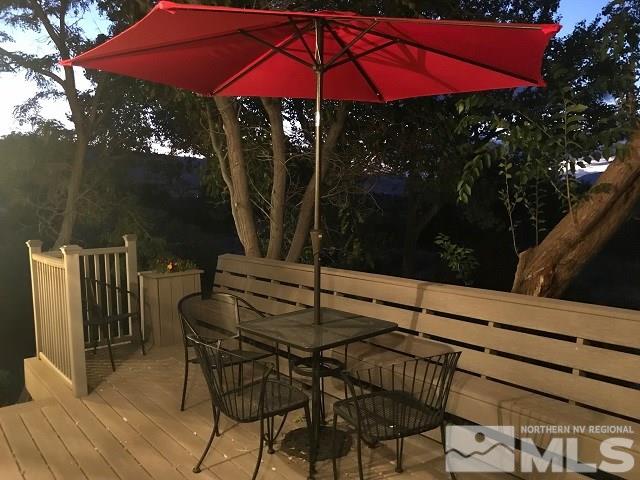 1435 Celese Lane Reno, NV 89511 - Photo 37 of 40 a patio with tables and chairs under an umbrella