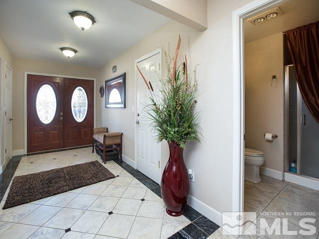 1435 Celese Lane Reno, NV 89511 - Photo 4 of 40 a living room with painting on the wall and a potted plant