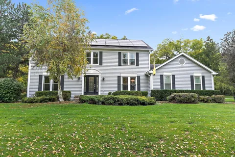 a view of a yard in front of a house with green space