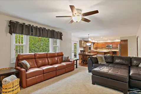 a kitchen with a dining table chairs sink and stove