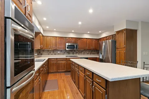 a kitchen with a dining table chairs and granite counter tops