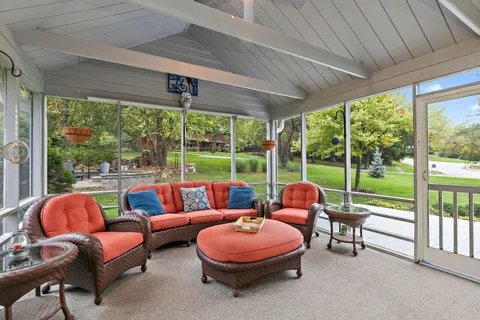 a view of a patio with table and chairs and potted plants