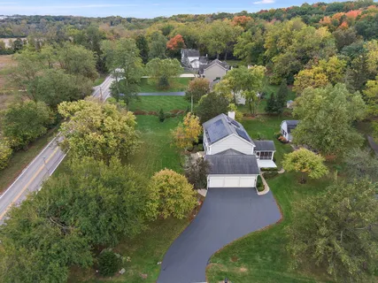 an aerial view of a houses with a lake view