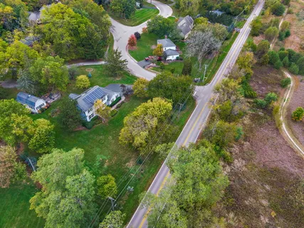 an aerial view of a house with a yard