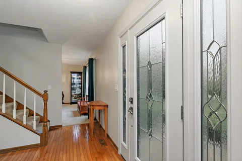 a view of a hallway with furniture and wooden floor