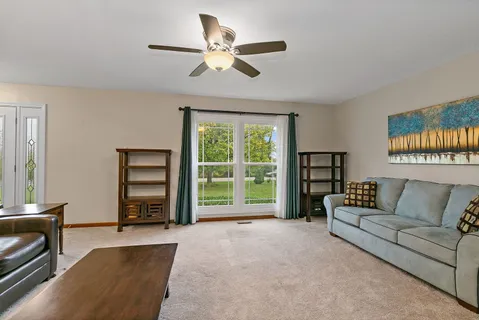 a living room with furniture and a flat screen tv with wooden floor