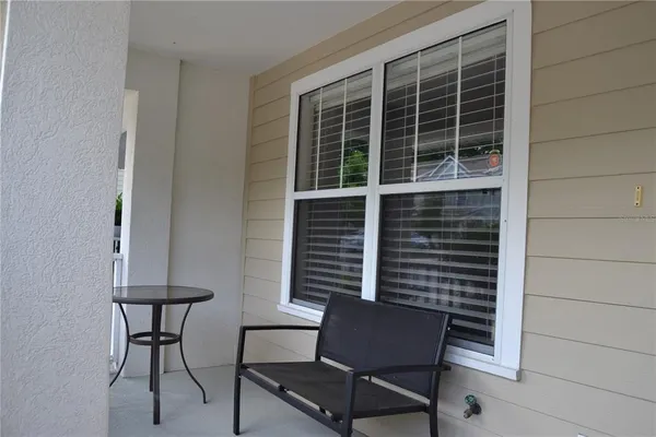 a bench and a table in a balcony