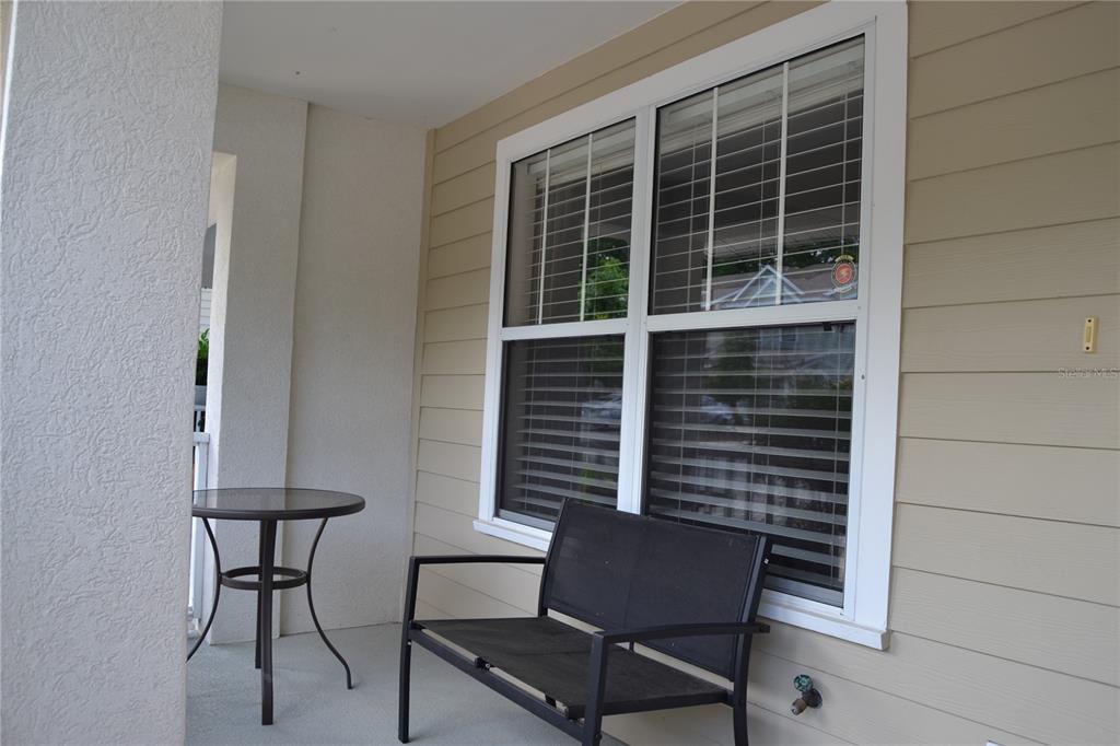 a bench and a table in a balcony