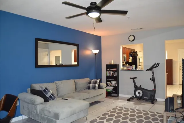 a living room with furniture a air conditioner vent and a window