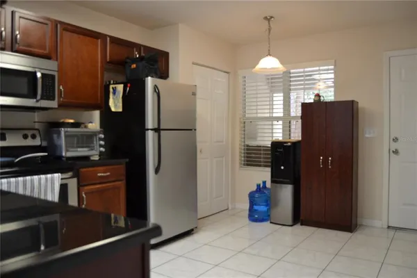 a kitchen with refrigerator and window