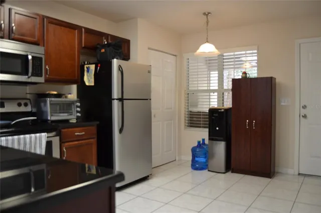 a kitchen with refrigerator and window