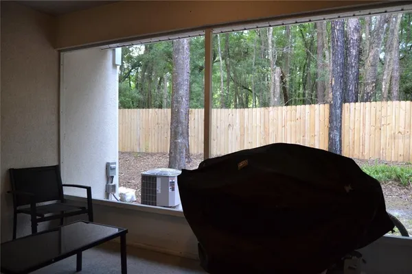 a bedroom with windows and closet