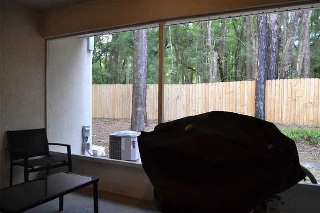 a bedroom with windows and closet