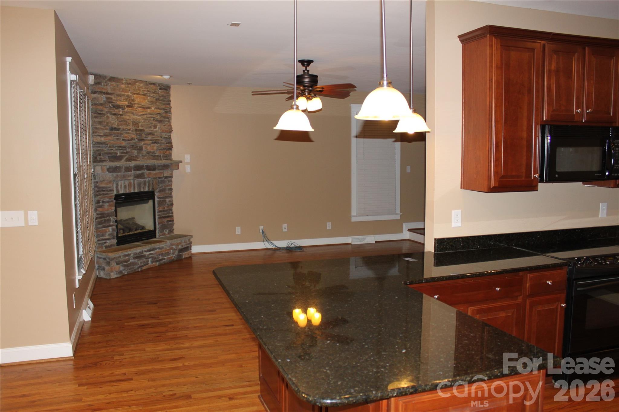 886 Promenade Walk Fort Mill, SC 29708 - Photo 10 of 14 a kitchen with granite countertop wooden cabinets and a stove