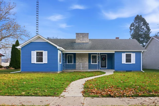 a front view of a house with a garden