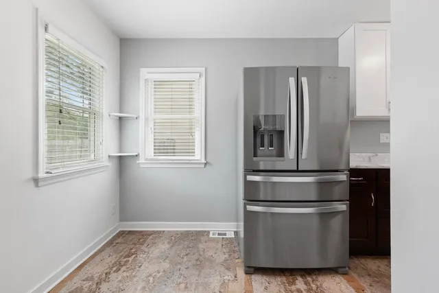 a kitchen with stainless steel appliances granite countertop a refrigerator and a stove