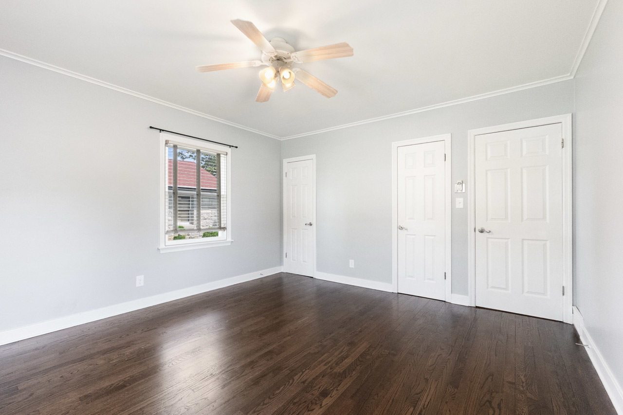 1209 Tilton Park Drive Rochelle, IL 61068 - Photo 18 of 26 an empty room with wooden floor ceiling fan and windows