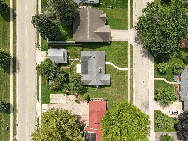 an aerial view of a house with outdoor space and street view