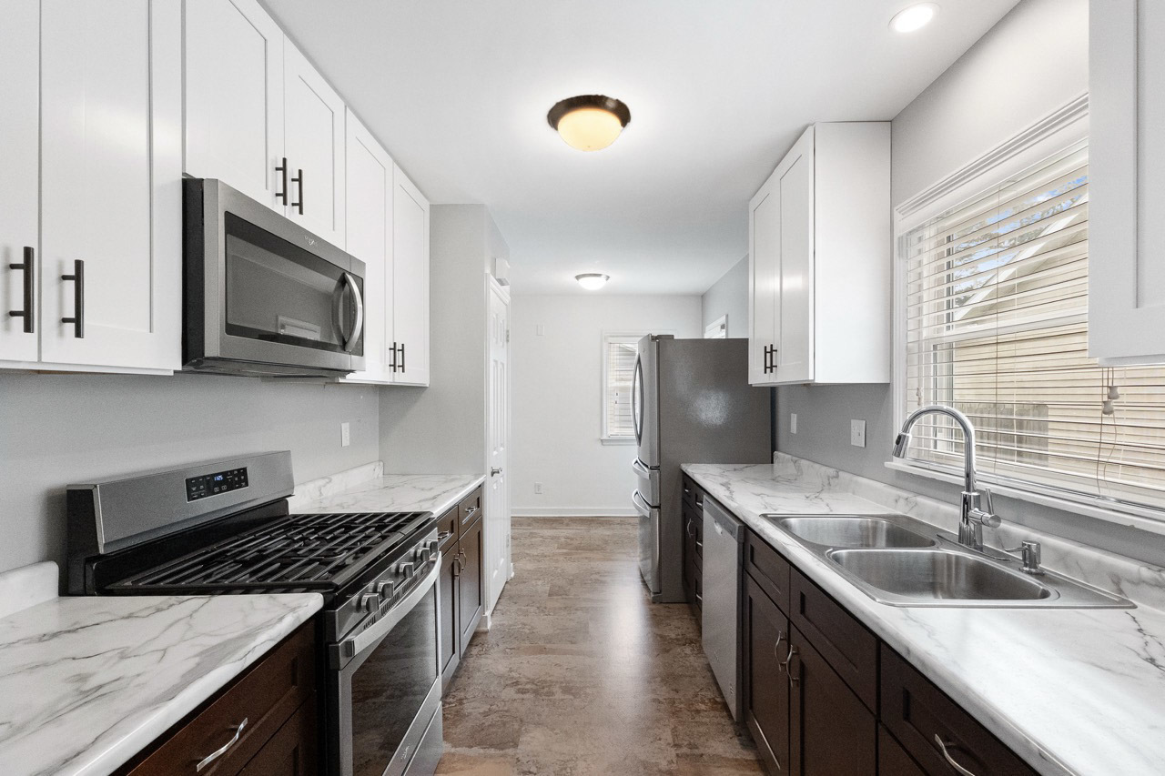 1209 Tilton Park Drive Rochelle, IL 61068 - Photo 8 of 26 a kitchen with stainless steel appliances granite countertop a sink stove microwave and refrigerator