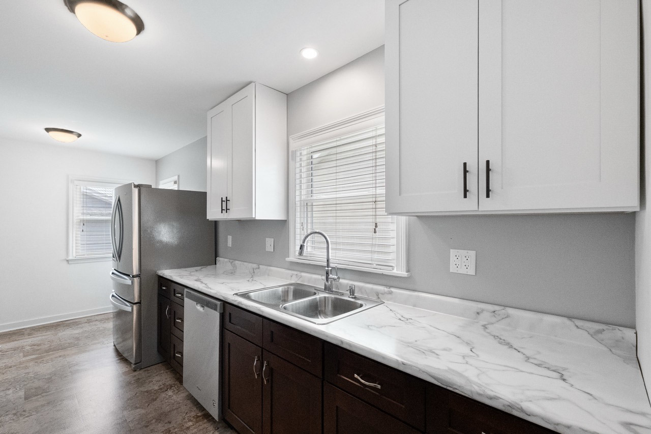 1209 Tilton Park Drive Rochelle, IL 61068 - Photo 9 of 26 a kitchen with stainless steel appliances granite countertop a sink refrigerator and cabinets