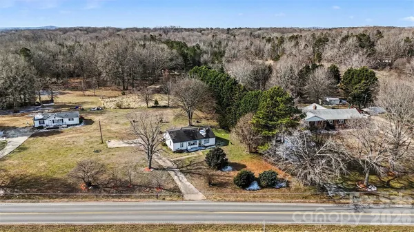 an aerial view of a house with a yard