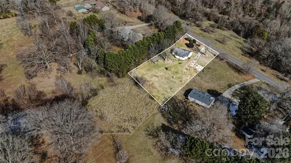 a view of a backyard with wooden fence