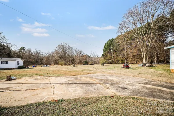 a view of yard with swimming pool and trees