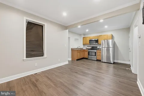 a view of kitchen with wooden floor and electronic appliances