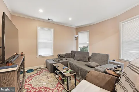 a bathroom with a sink a toilet and a window