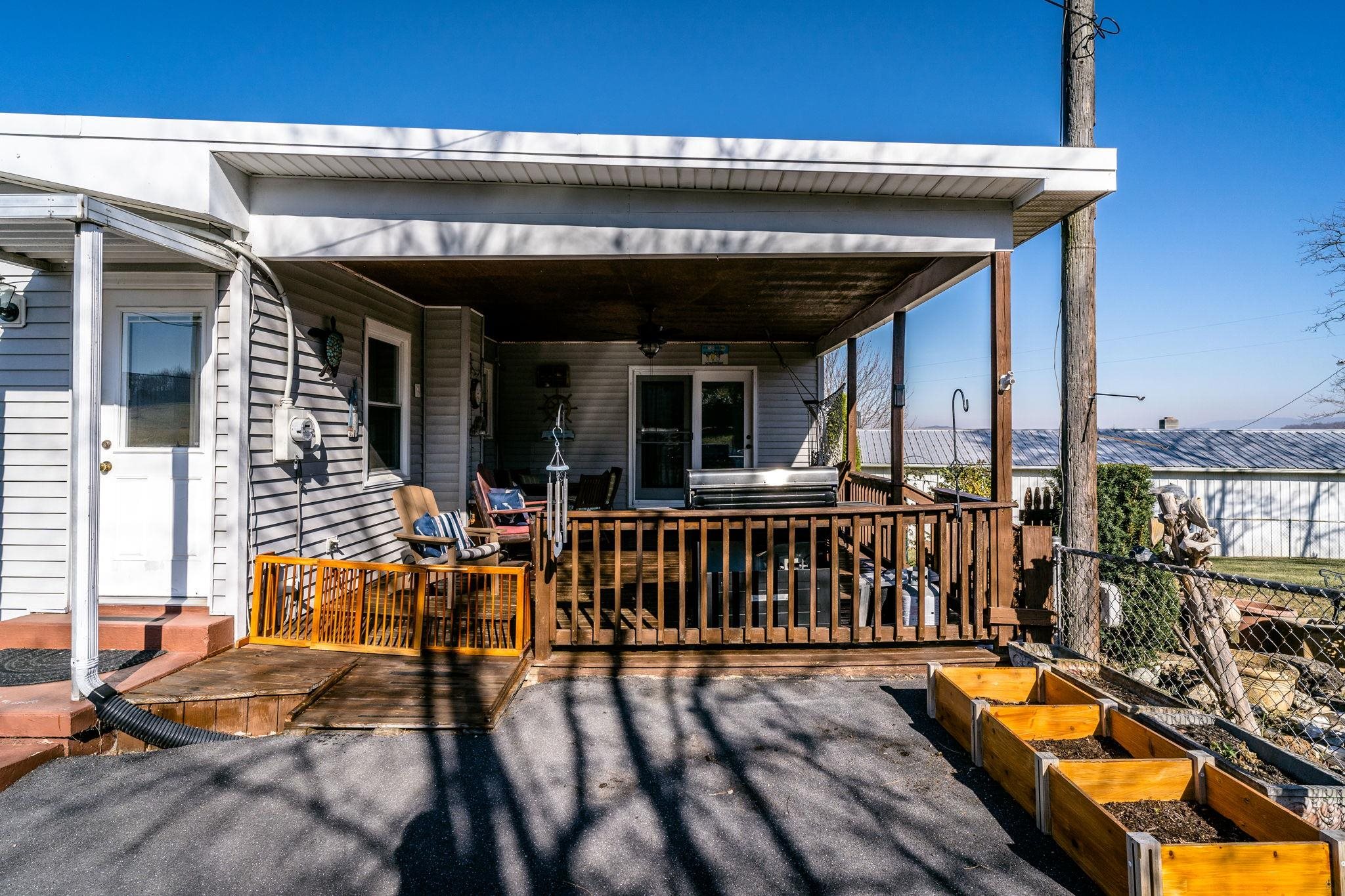 3154 Layman Trestle Road Harrisonburg, VA 22802 - Photo 17 of 30 a view of a patio with table and chairs with wooden floor and fence