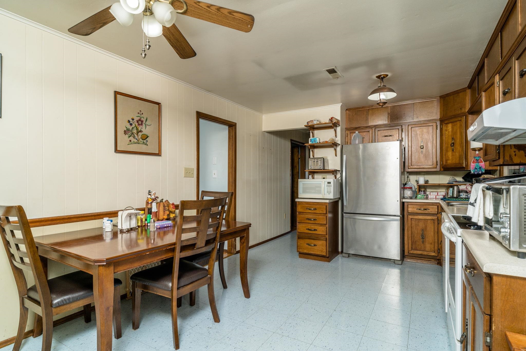 3154 Layman Trestle Road Harrisonburg, VA 22802 - Photo 3 of 30 a kitchen with refrigerator and chairs