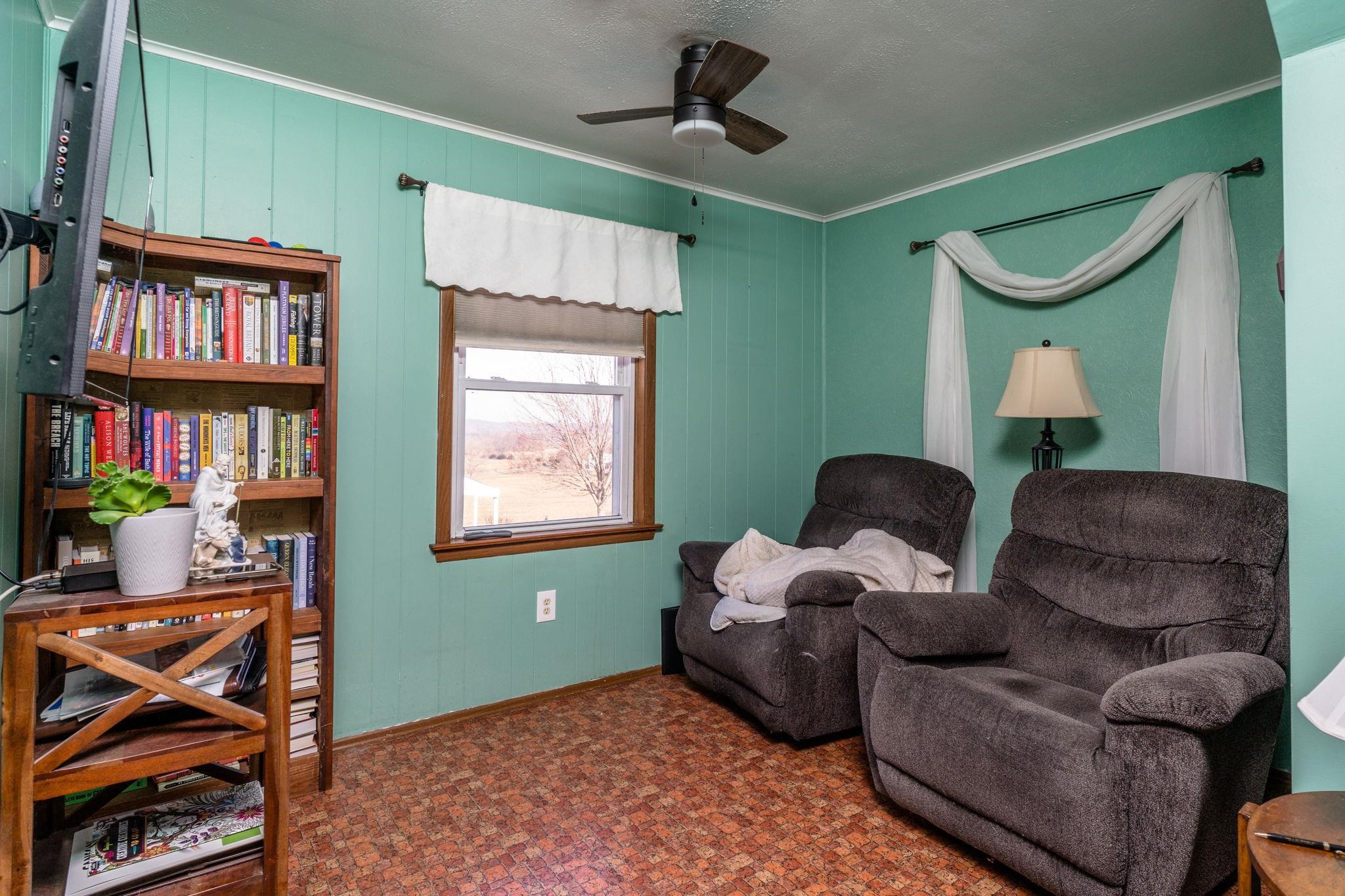 3154 Layman Trestle Road Harrisonburg, VA 22802 - Photo 9 of 30 a living room with furniture a window and a bookshelf